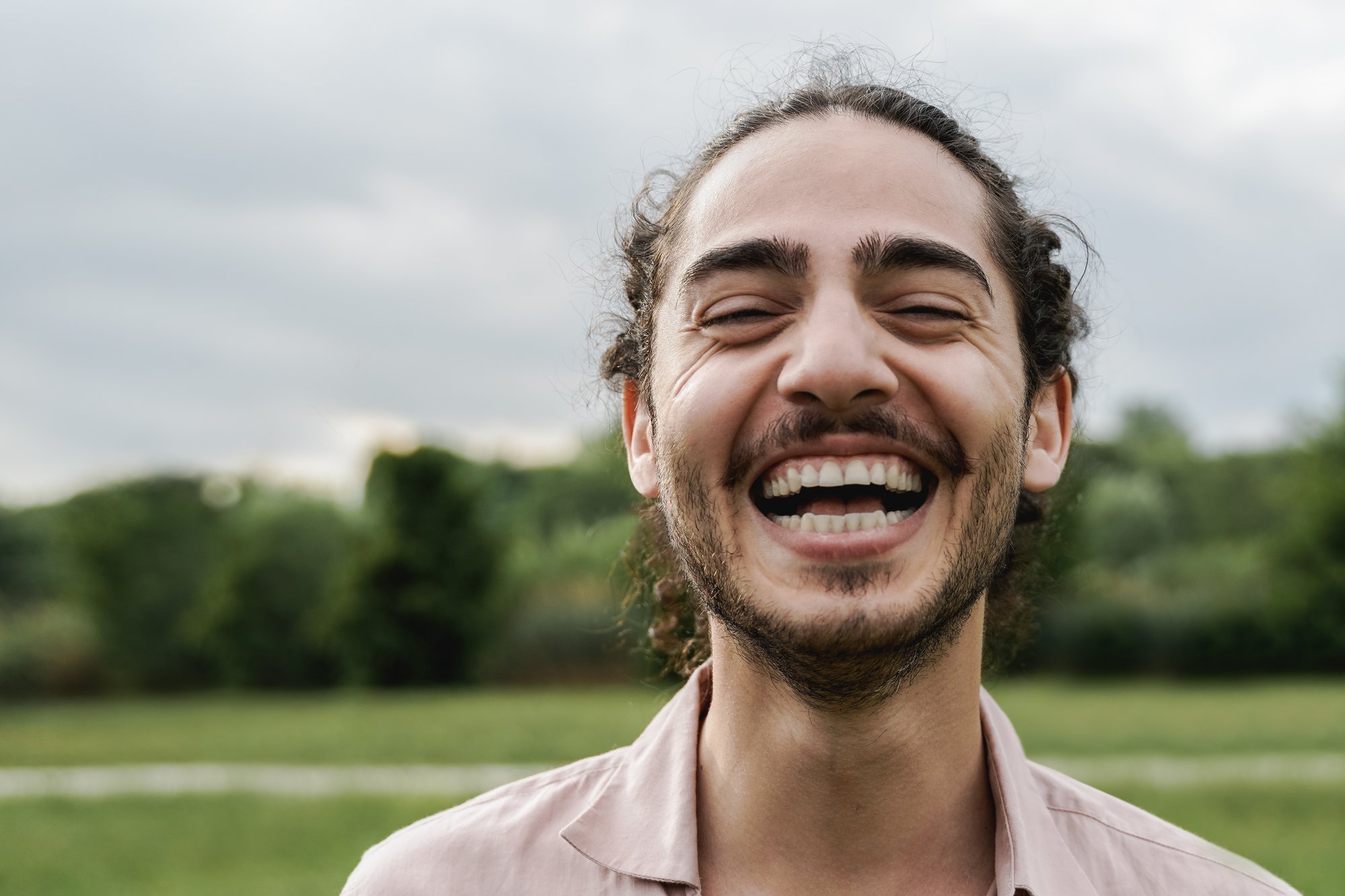 young-happy-man-smiling-and-looking-at-camera-outd-2022-06-08-15-12-21-utc young-happy-man-smiling-and-looking-at-camera-outd-2022-06-08-15-12-21-utc